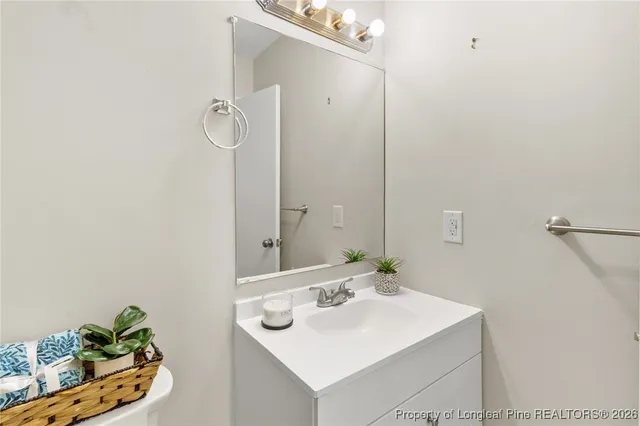 a bathroom with a sink mirror and vanity