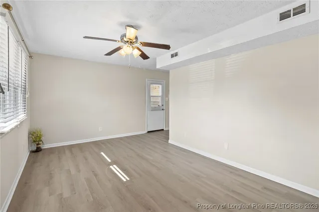 wooden floor in an empty room with a window