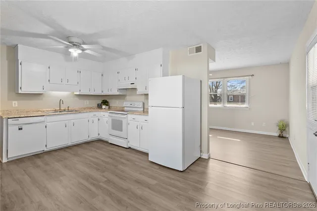 a kitchen with a refrigerator a sink and dishwasher