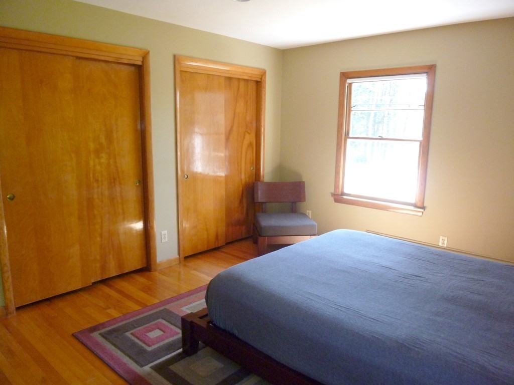 625 Westhampton Road Northampton, MA 01062 - Photo 15 of 30 a bedroom with a bed and wooden floor