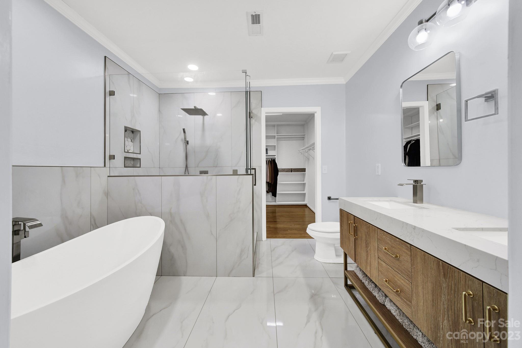 a spacious bathroom with a bathtub shower sink and mirror