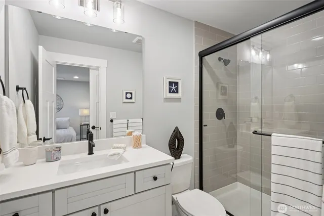 a bathroom with a sink a toilet and shower