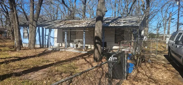 a view of a house with a tree in front of it