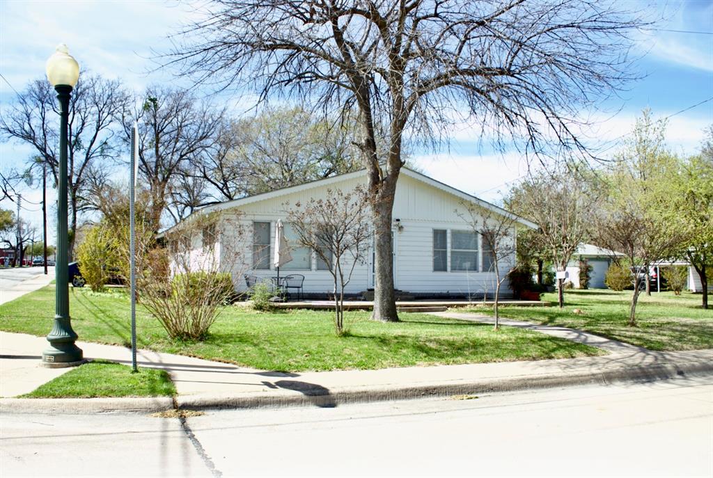 a house that has a tree in front of it