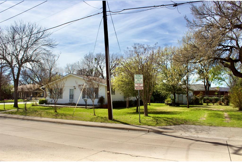 422 Smith Street Grapevine, TX 76051 - Photo 2 of 9 a view of a tall building in a park with trees