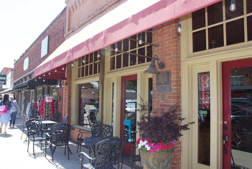 422 Smith Street Grapevine, TX 76051 - Photo 6 of 9 a front view of a building with red flowers