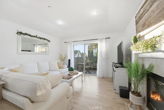 a living room with furniture a flat screen tv and a floor to ceiling window