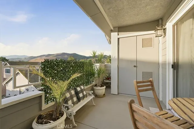 a balcony with furniture and a potted plant