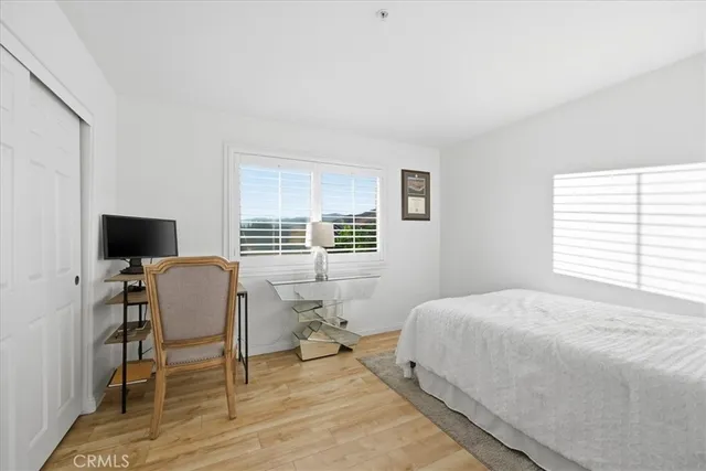 a bedroom with a bed and a chair