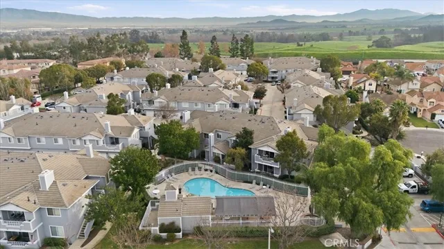 an aerial view of residential houses with outdoor space and river