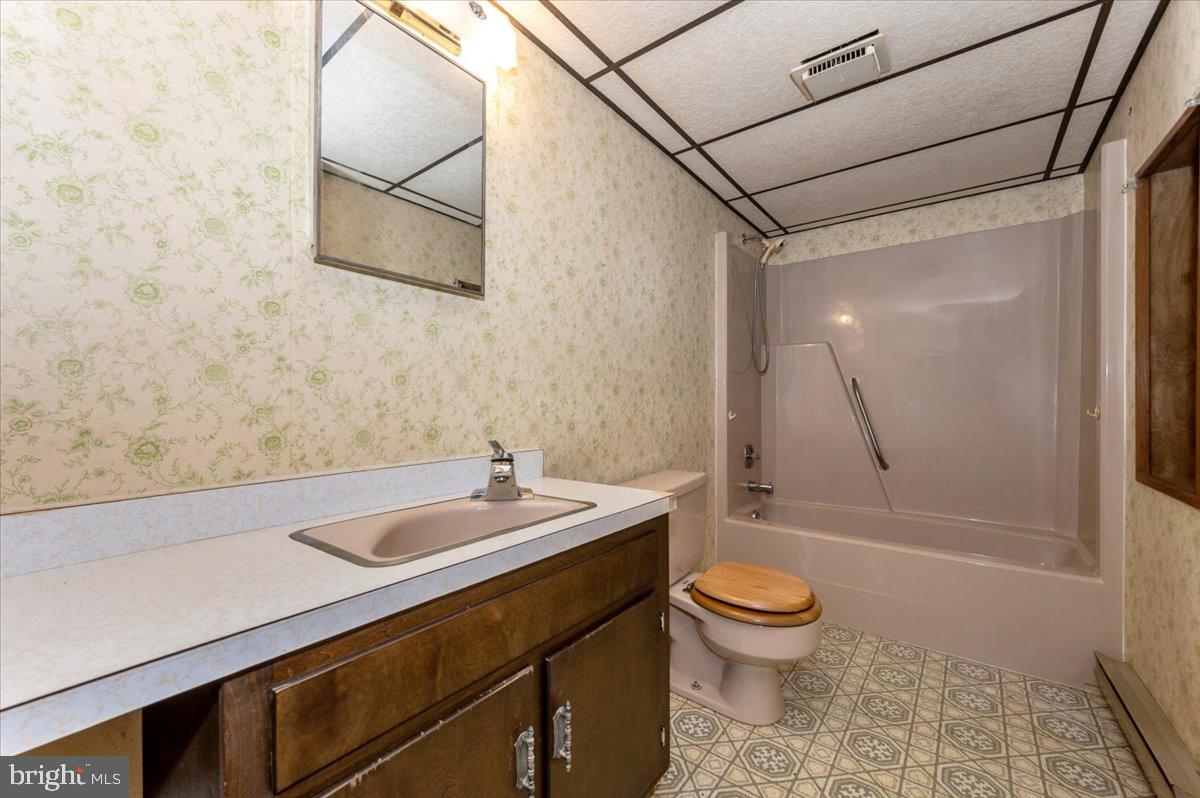 10622 National Pike Big Pool, MD 21711 - Photo 20 of 60 a bathroom with a granite countertop sink toilet and shower