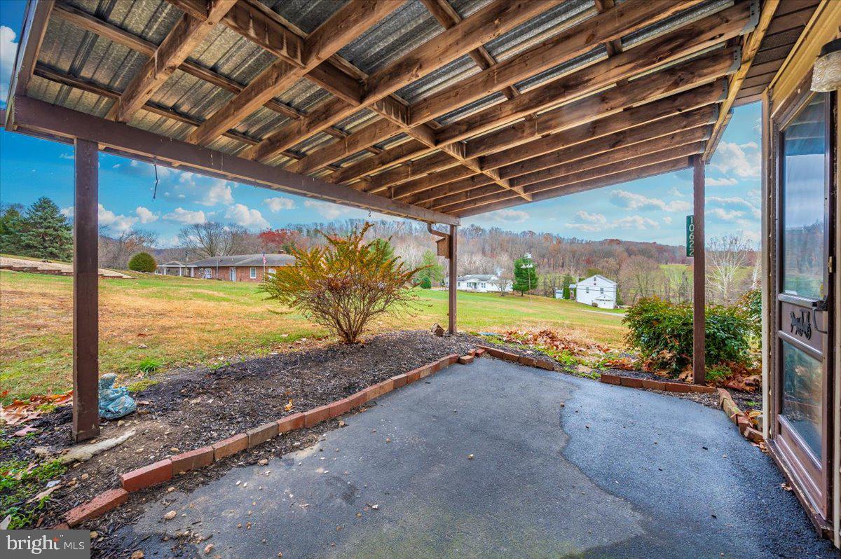 10622 National Pike Big Pool, MD 21711 - Photo 41 of 60 a view of a room with wooden floor next to a yard