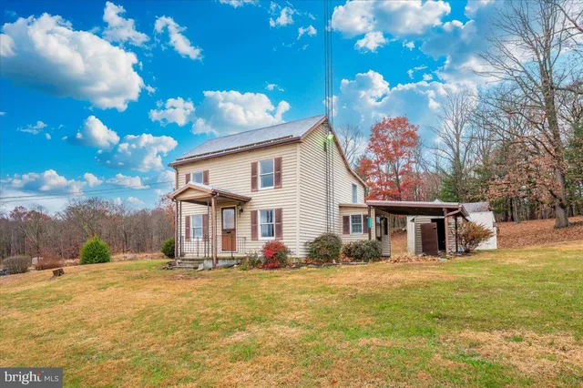 a living room with furniture a flat screen tv and a large window