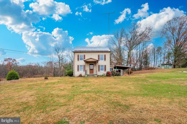 a view of a dining room with furniture and a chandelier