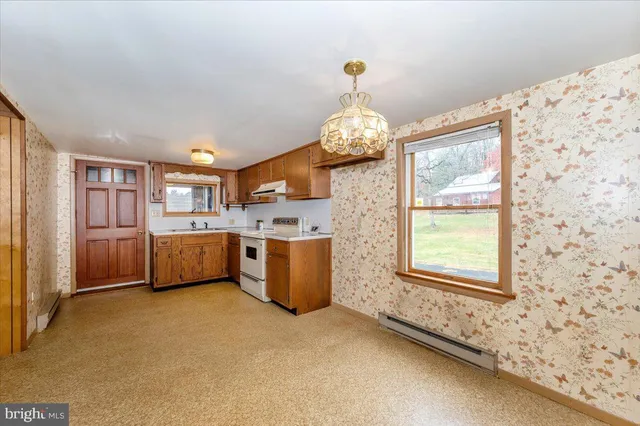 a kitchen with a sink refrigerator and cabinets