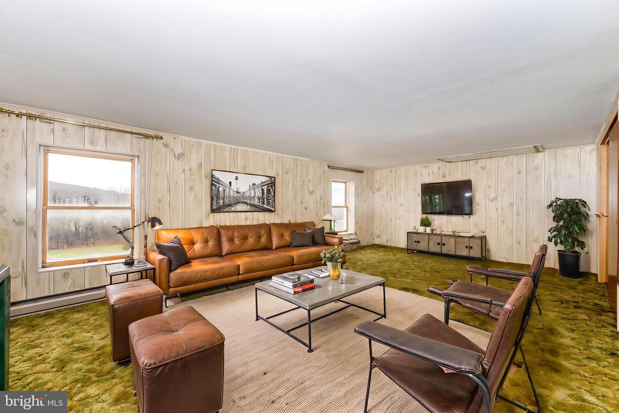 10622 National Pike Big Pool, MD 21711 - Photo 54 of 60 a living room with furniture and a flat screen tv