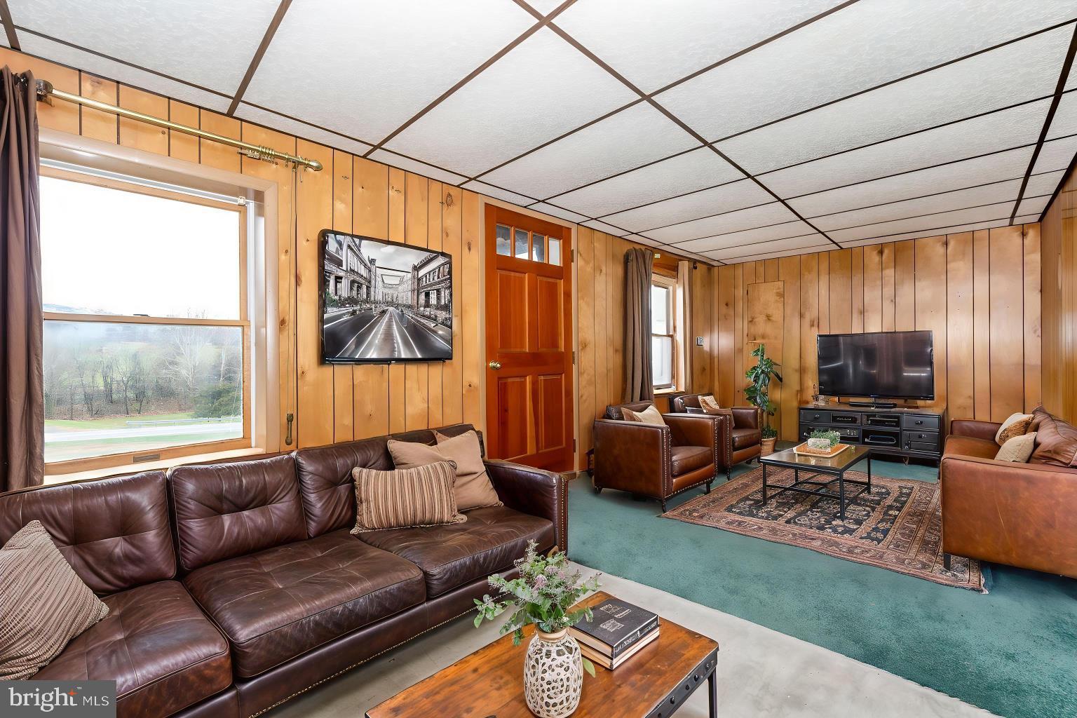 10622 National Pike Big Pool, MD 21711 - Photo 56 of 60 a living room with furniture a flat screen tv and a large window
