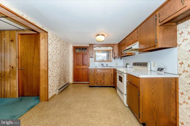 a kitchen with granite countertop cabinets stainless steel appliances and a sink