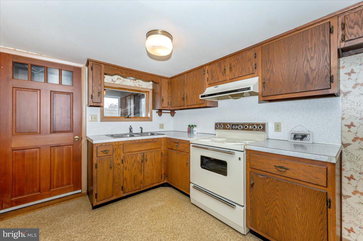 10622 National Pike Big Pool, MD 21711 - Photo 7 of 60 a kitchen with granite countertop cabinets stainless steel appliances and a sink