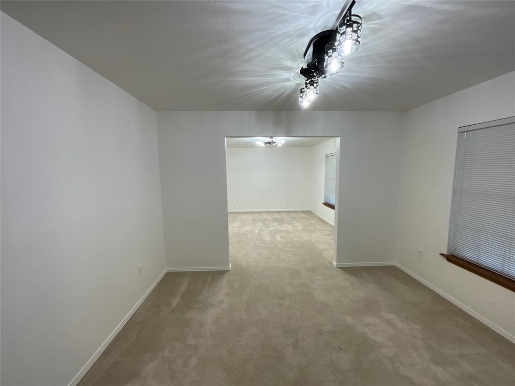 999 West Boynton Street Hamilton, TX 76531 - Photo 11 of 26 wooden floor in an empty room