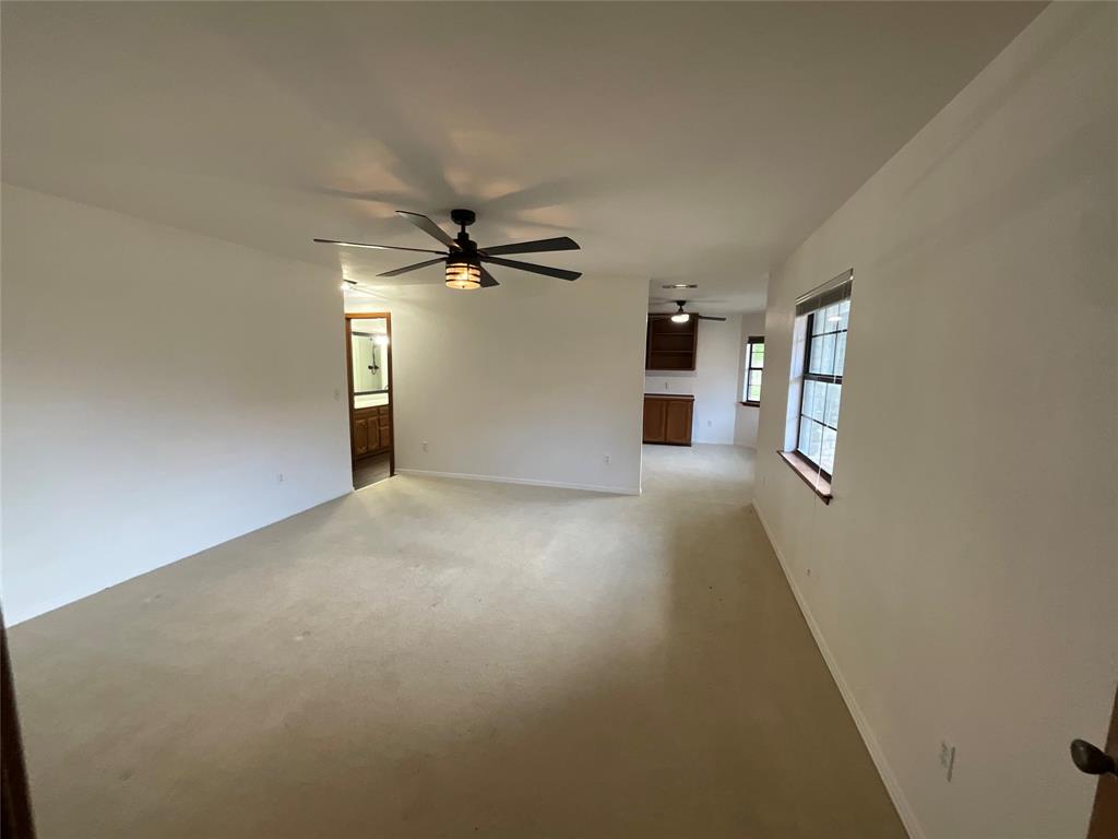 999 West Boynton Street Hamilton, TX 76531 - Photo 13 of 26 a view of a livingroom with a ceiling fan and window