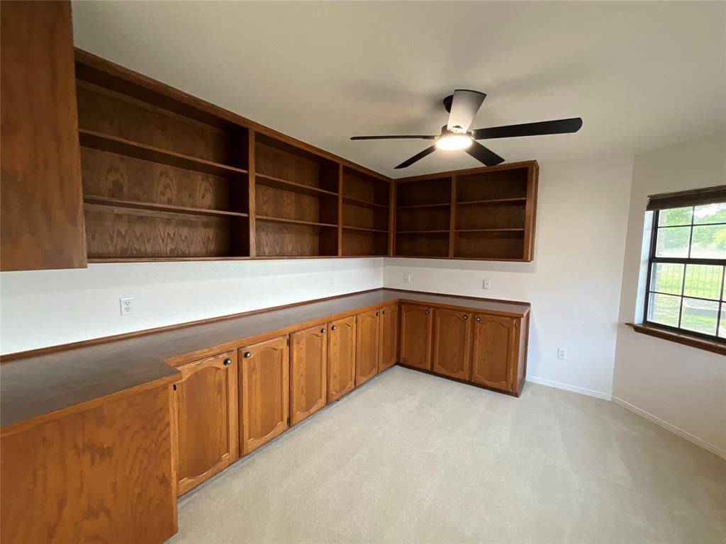 999 West Boynton Street Hamilton, TX 76531 - Photo 14 of 26 a kitchen with a cabinets and chandelier