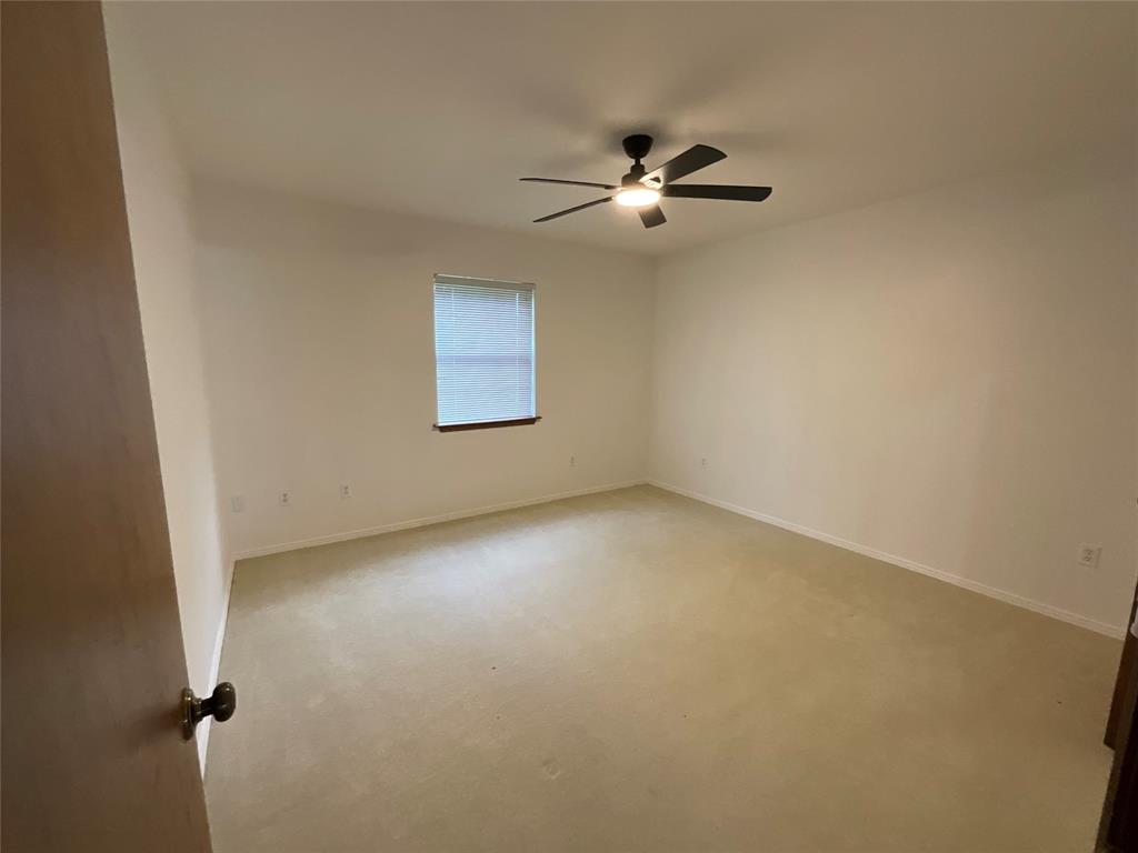 999 West Boynton Street Hamilton, TX 76531 - Photo 16 of 26 a view of an empty room with a window