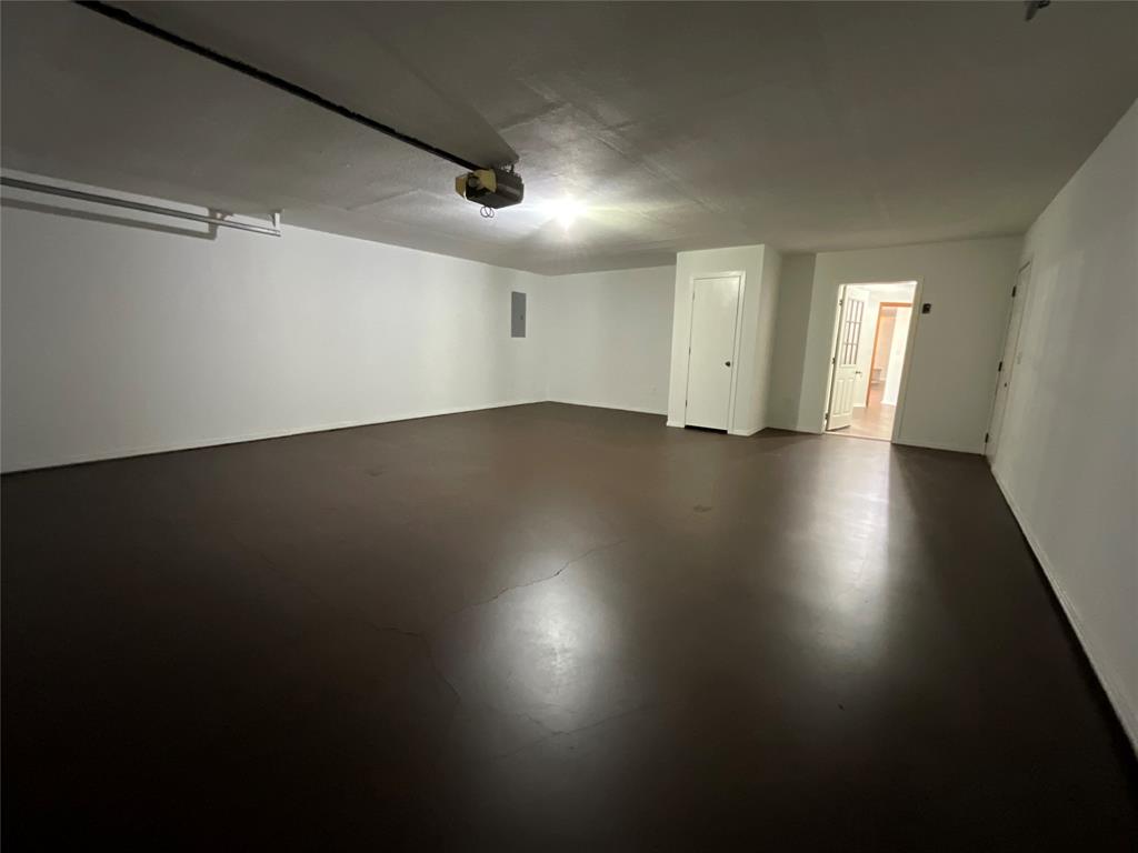 999 West Boynton Street Hamilton, TX 76531 - Photo 20 of 26 an empty room with wooden floor and windows