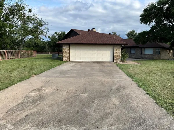 a view of a house with a yard garage and entertaining space