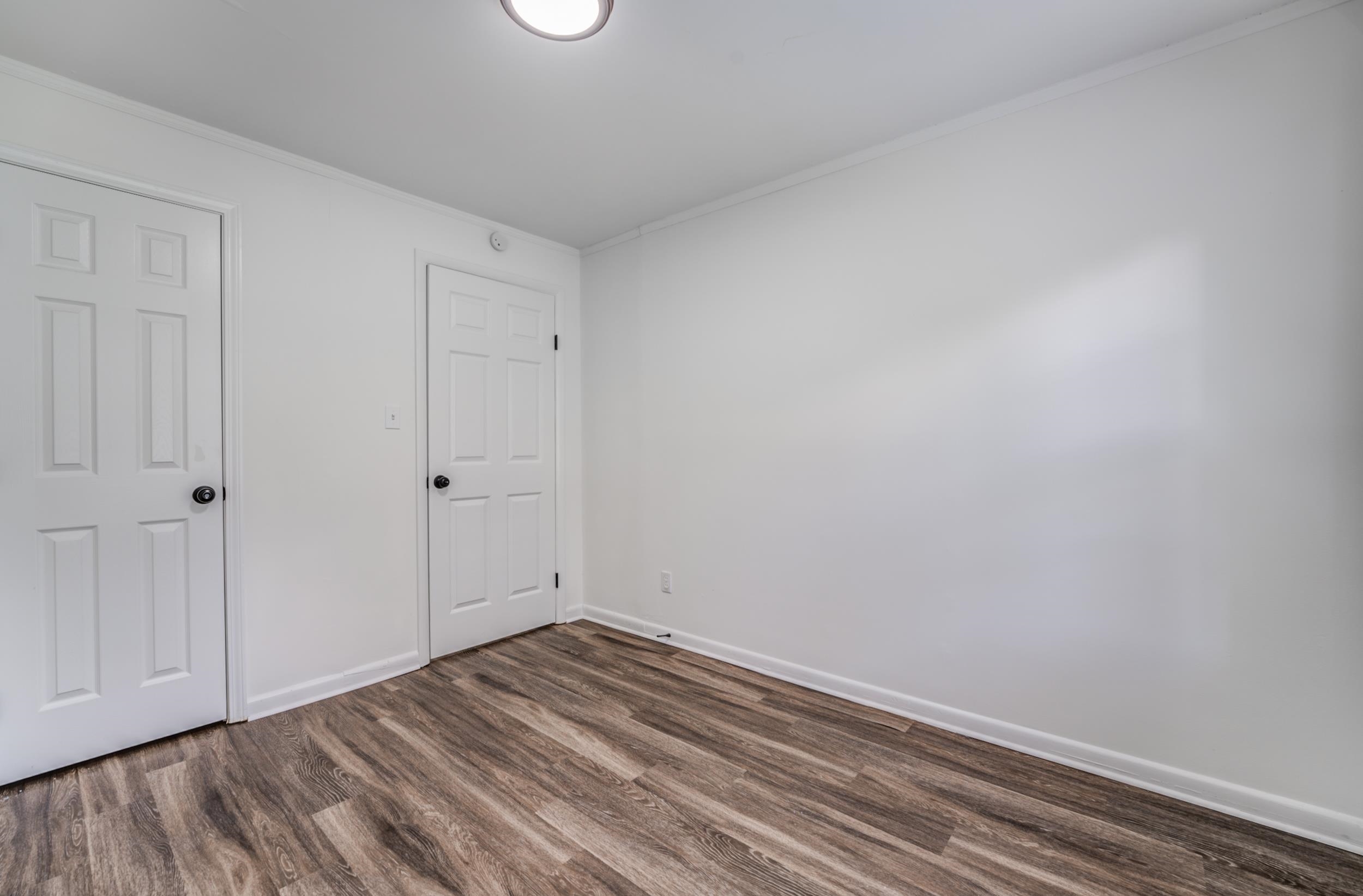 4903 Quince Road Memphis, TN 38117 - Photo 20 of 20 Unfurnished bedroom with ornamental molding and dark wood-style floors