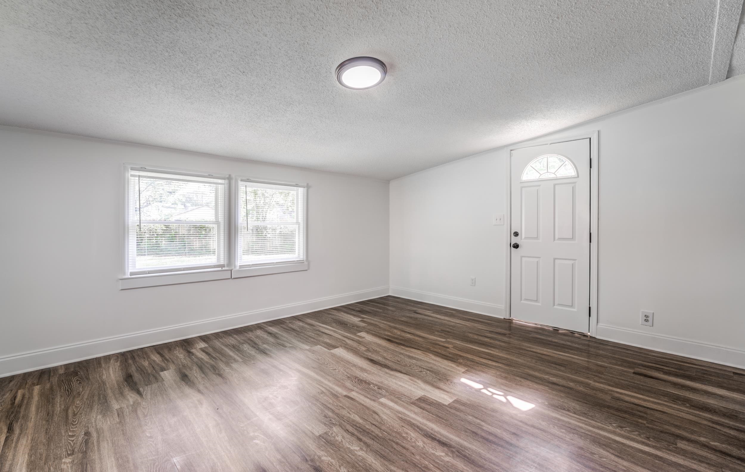 4903 Quince Road Memphis, TN 38117 - Photo 9 of 20 Foyer with a textured ceiling and dark wood-style flooring