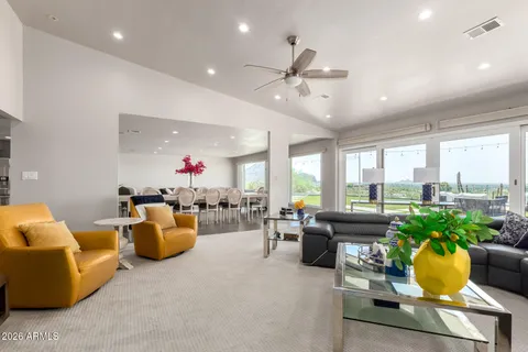 a living room filled with furniture and a large window