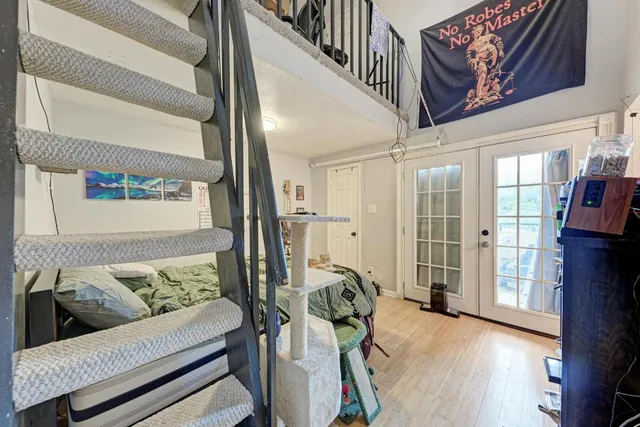 a view of a livingroom with furniture and floor to ceiling window
