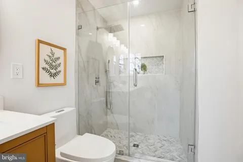 a bathroom with a shower a toilet and a sink
