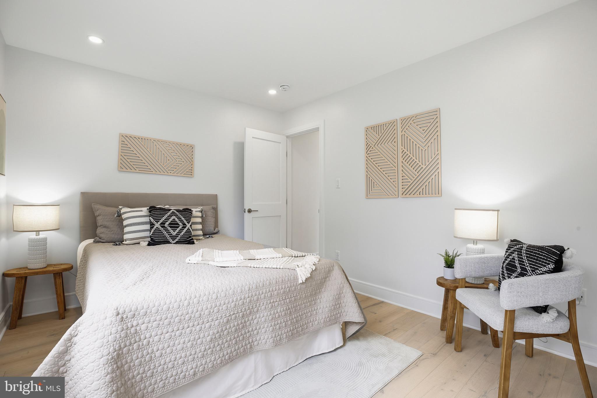 14828 Fireside Drive Silver Spring, MD 20905 - Photo 24 of 54 a bedroom with a bed and a lamp on table
