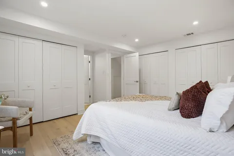 a spacious bedroom with a bed and a table