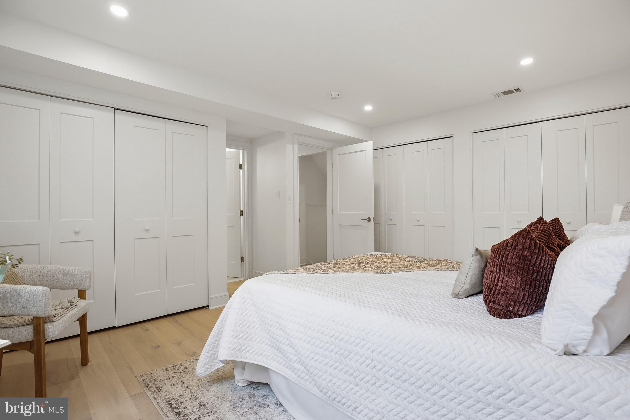 14828 Fireside Drive Silver Spring, MD 20905 - Photo 32 of 54 a spacious bedroom with a bed and a table