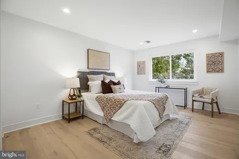 a bedroom with two beds and a window