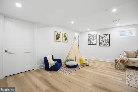 a view of a room with wooden floor and windows