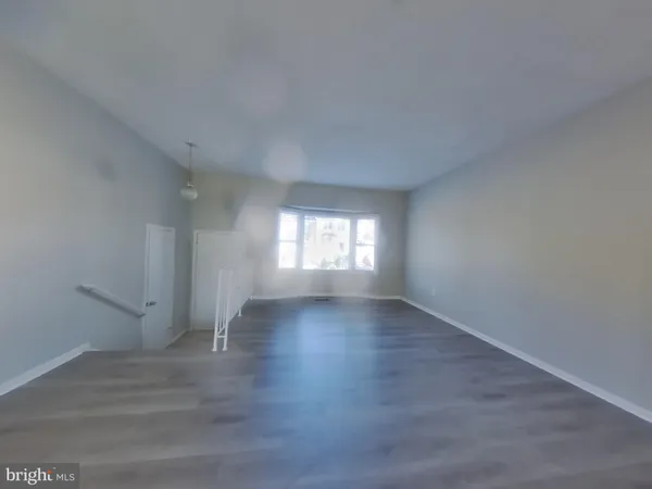 a view of wooden floor and windows in an empty room
