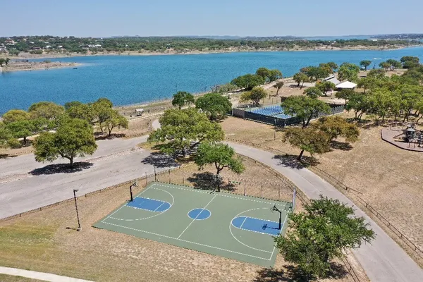 an aerial view of ocean and residential houses with outdoor space