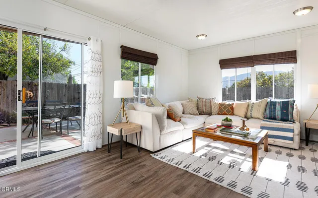 a living room with furniture and a floor to ceiling window