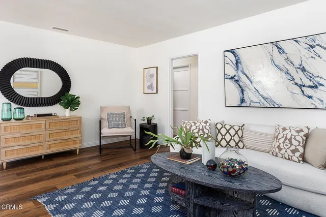 a living room with furniture and a rug