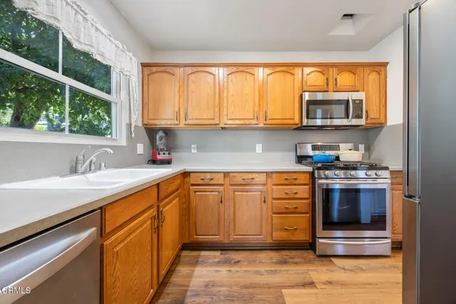 a kitchen with stainless steel appliances granite countertop a sink and cabinets