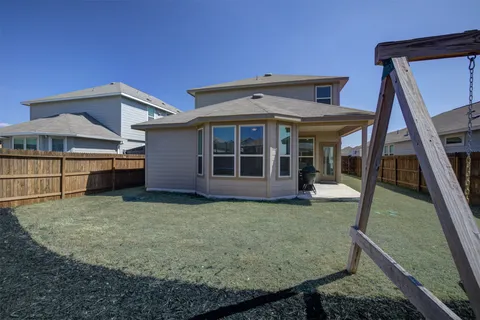 a view of a house with backyard and deck