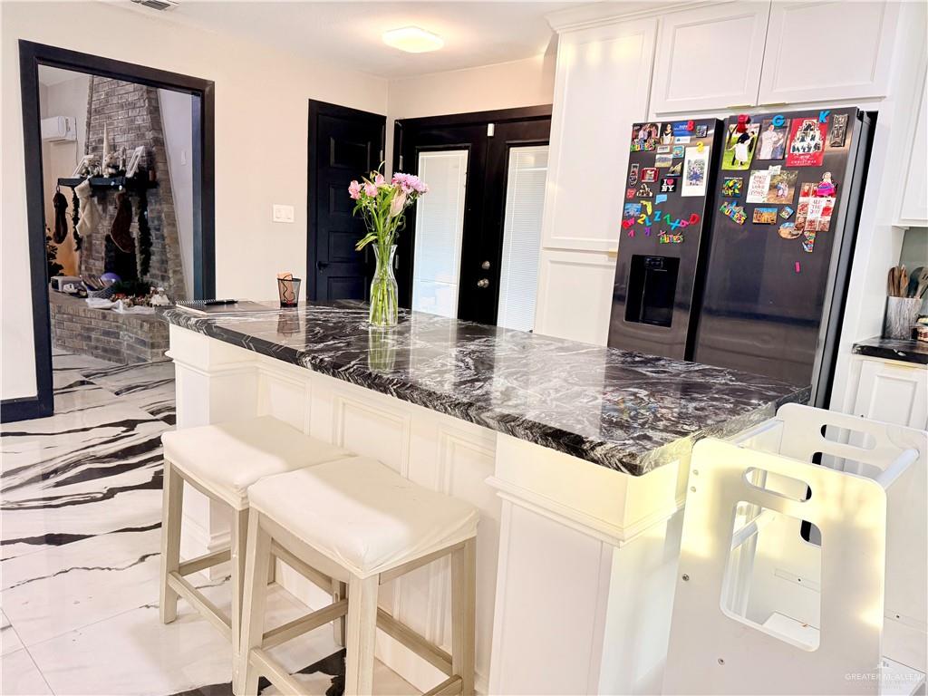 940 West Mile 3 Road Mission, TX 78573 - Photo 15 of 25 a kitchen with stainless steel appliances granite countertop a sink and a refrigerator