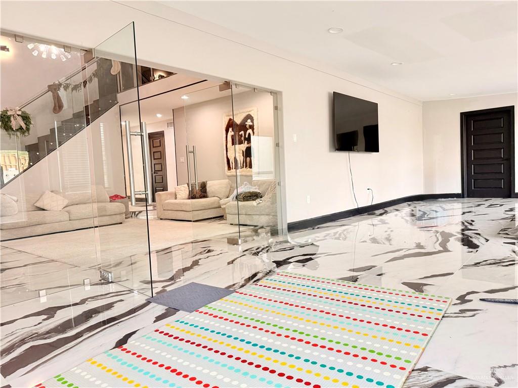 940 West Mile 3 Road Mission, TX 78573 - Photo 18 of 25 a living room with a bed and a flat screen tv