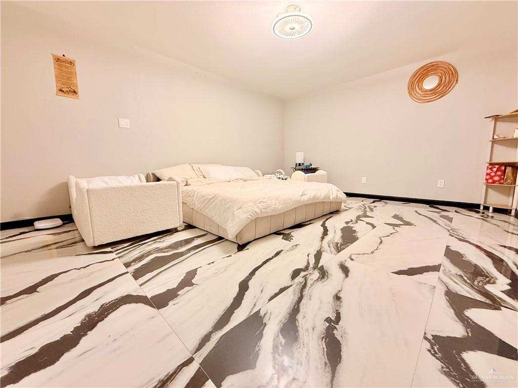 940 West Mile 3 Road Mission, TX 78573 - Photo 19 of 25 a bedroom with a bed and a couch