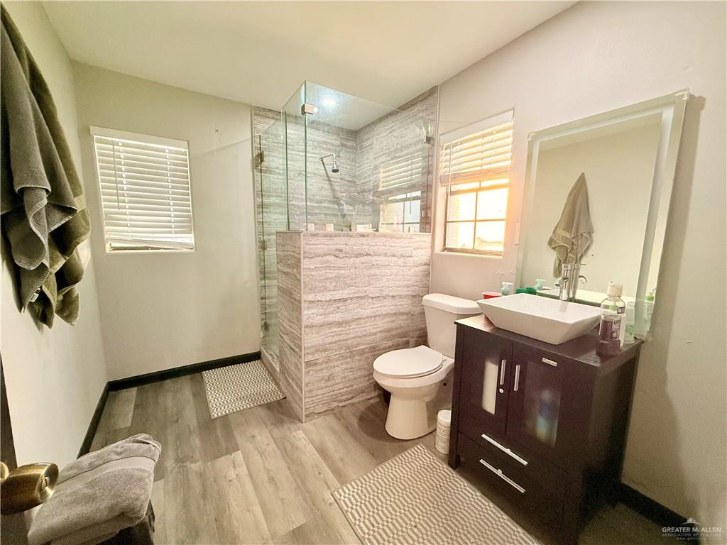 940 West Mile 3 Road Mission, TX 78573 - Photo 22 of 25 a bathroom with a sink toilet and window