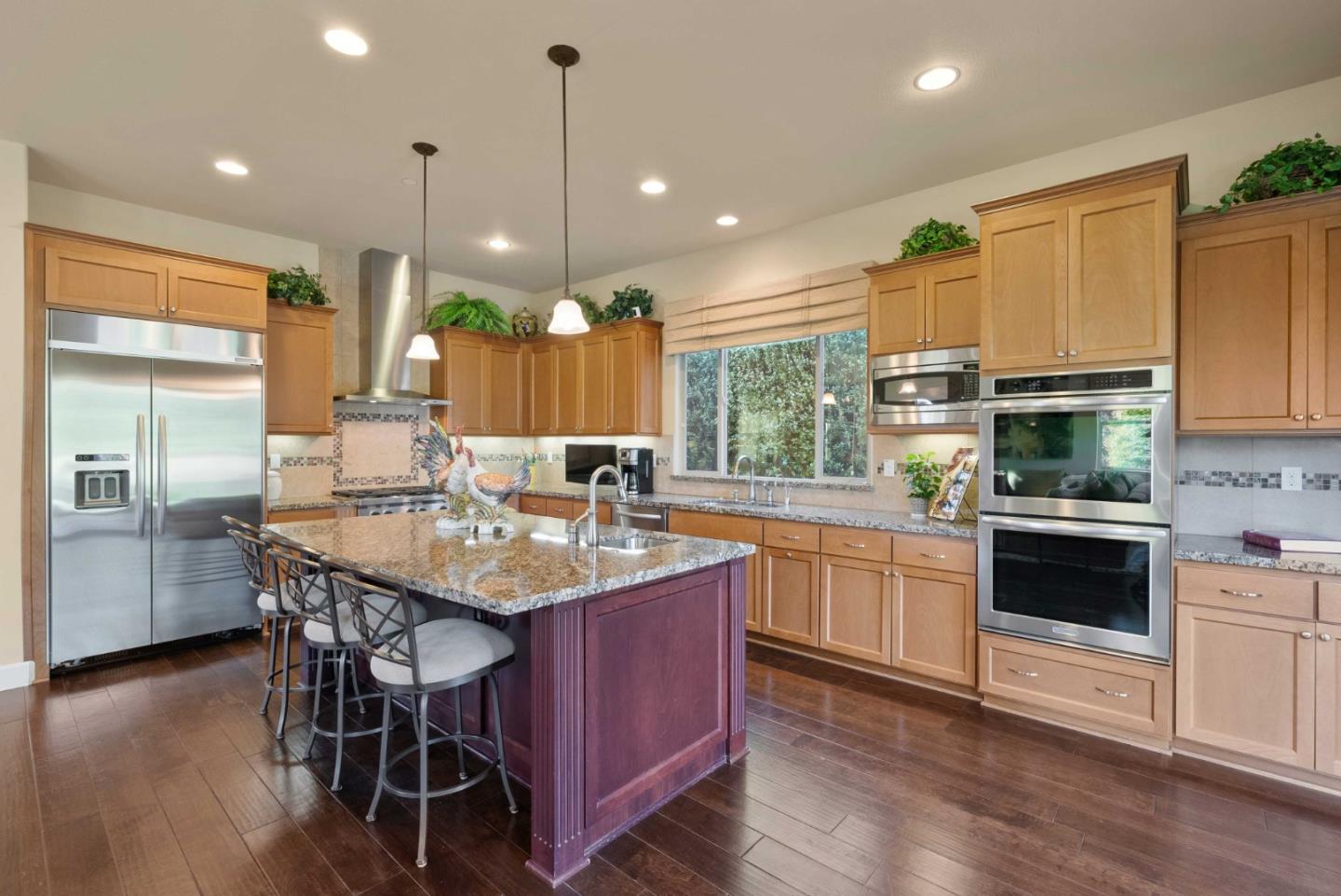 1477 Corte De Maria San Jose, CA 95120 - Photo 7 of 29 a kitchen with stainless steel appliances granite countertop a kitchen island hardwood floor sink stove and wooden cabinets